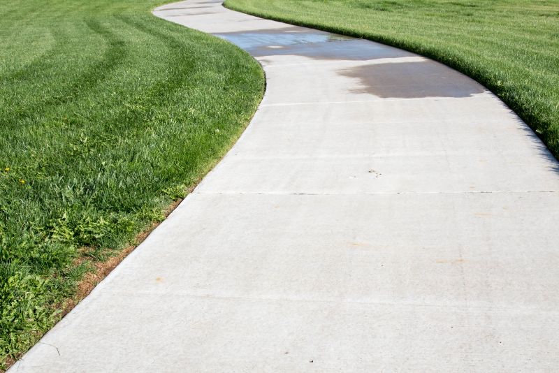 Finished concrete footpath alongside a residential property
