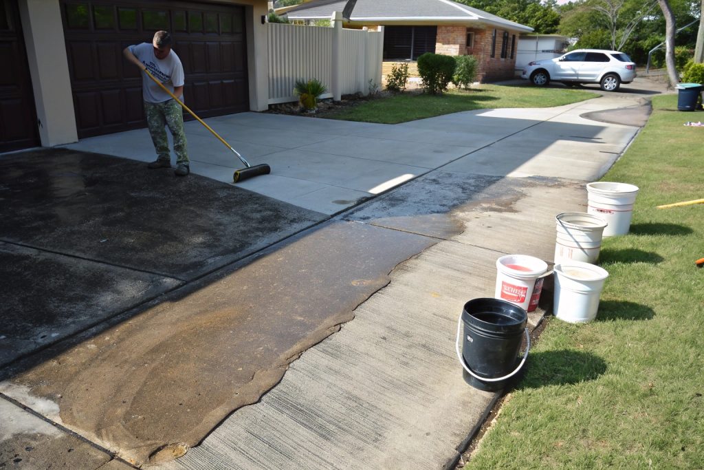 Concrete sealing comparison showing half a Woodridge driveway properly sealed and protected versus half untreated and weathered.