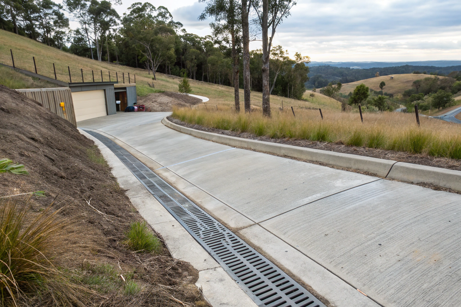 Concrete driveway on a sloped rural property