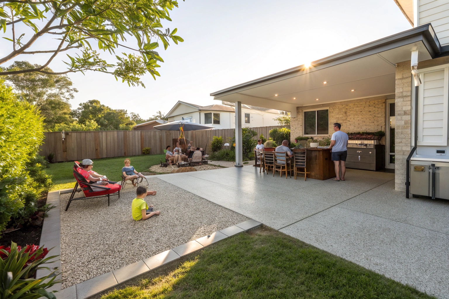 Exposed aggregate concrete patio slab in Logan backyard with outdoor entertaining area