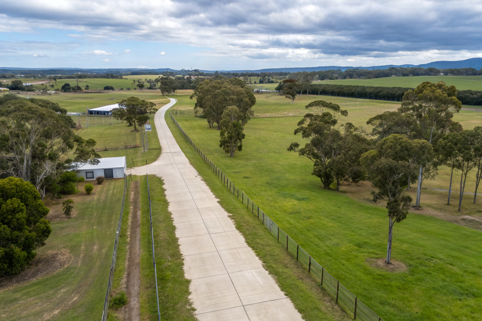Aerial view of a long, winding concrete driveway