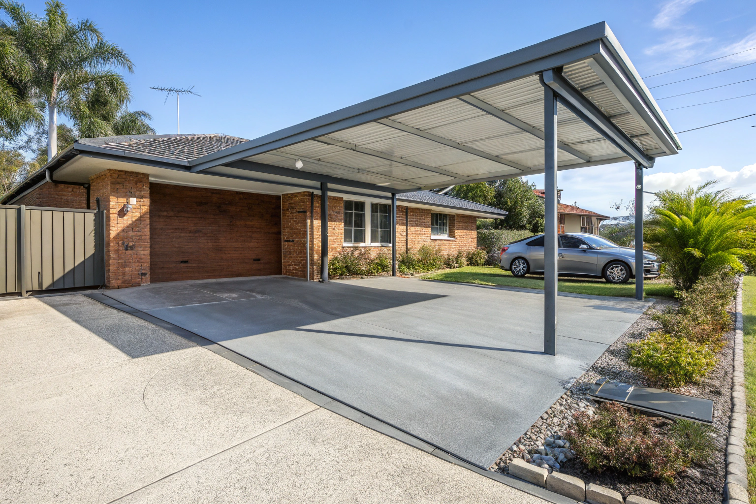 Modern residential carport with a concrete slab base