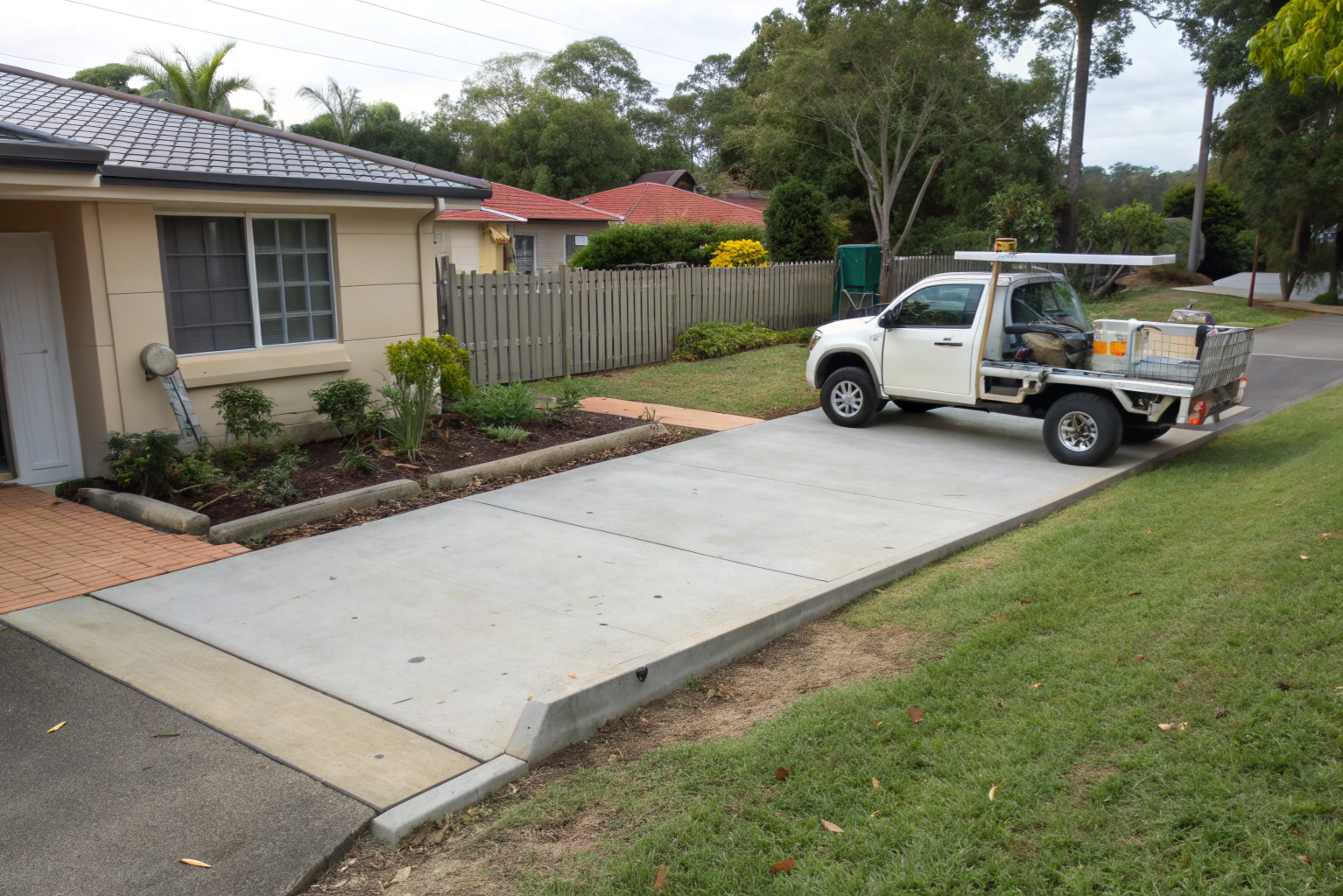 Small concrete parking pad beside an Australian home